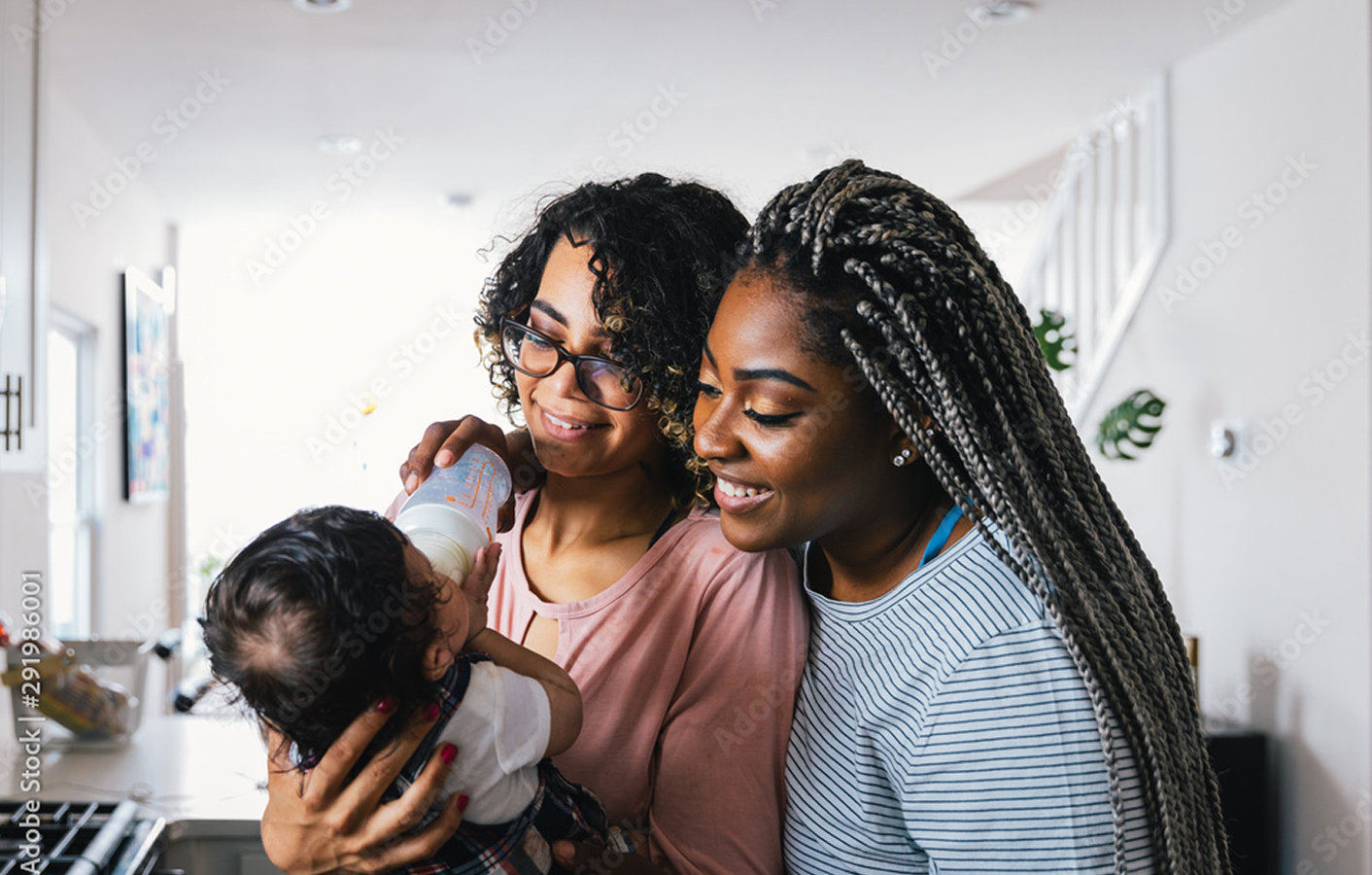 two black women holding a baby